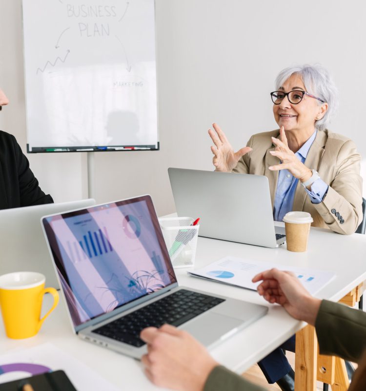 Business colleagues sitting at meeting room discussing about corporate project Group of professional business colleagues sitting at meeting room discussing about corporate project